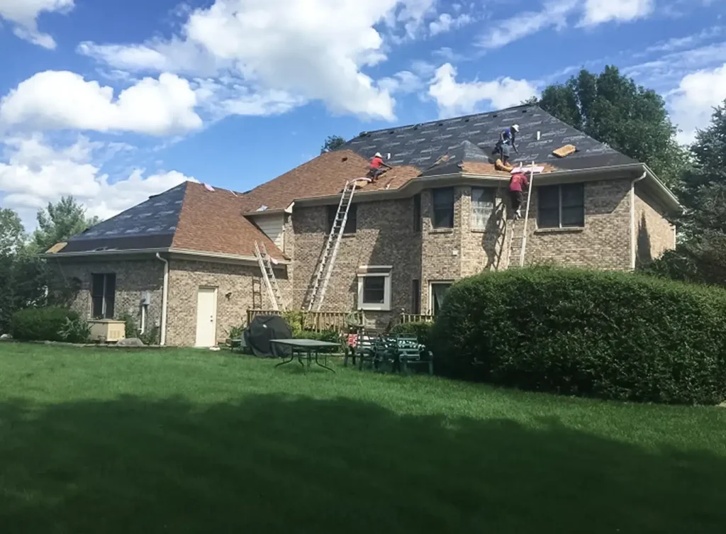 Roofing replacement company working on a house near effingham illinois