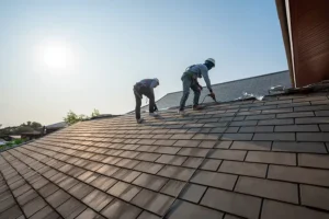 BAM Roofing & Construction—Roofers working on replacing roofing tiles on a roof in a Central IL residence.