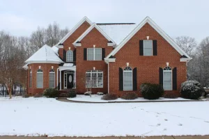 BAM Roofing & Construction—A brick home covered in Central Illinois snow.