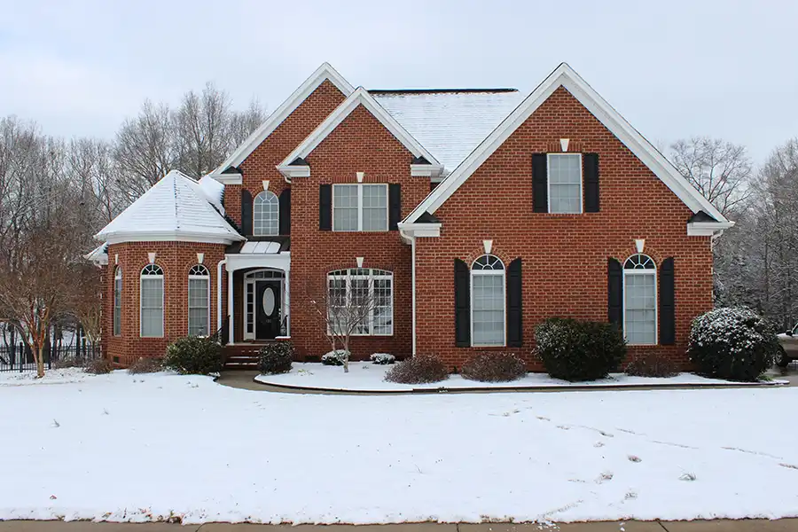 BAM Roofing & Construction—A brick home covered in Central Illinois snow.
